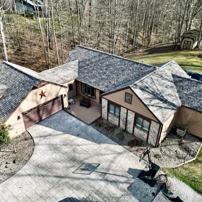 Aerial view of a completed roof restoration on a hillside home
